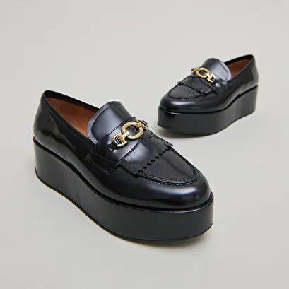 Gold buckle loafers in black glazed leather