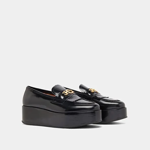 Gold buckle loafers in black glazed leather