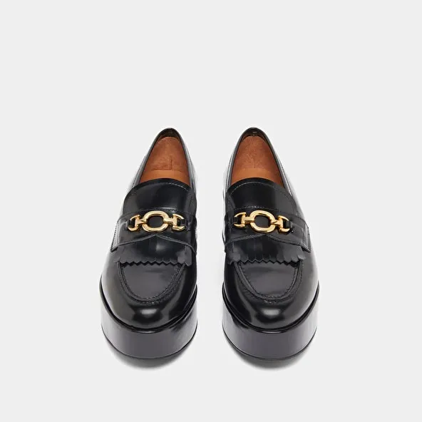 Gold buckle loafers in black glazed leather